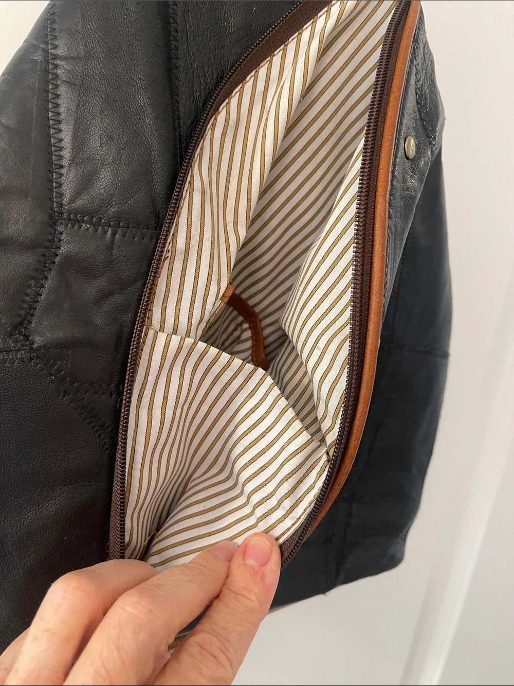 Black Leather Backpack with Brown Trim and Brass Accents